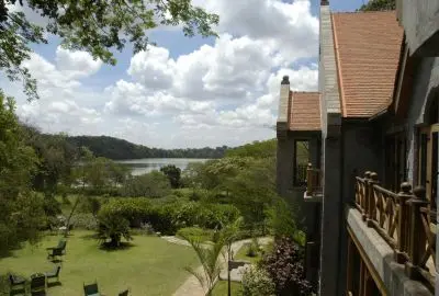 Lodge balconies looking out over green lawns and a lake near Arusha