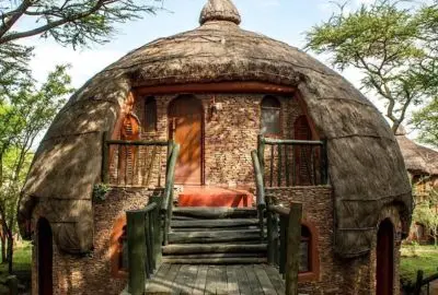 A domed thatched suite tucked into a Serengeti kopje
