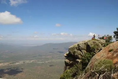 Travellers on a cliff-edge viewpoint high above the northern plains