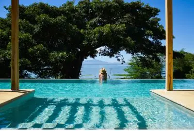 Infinity pool framed by a fever tree, looking out over Lake Naivasha