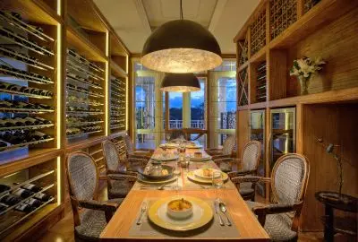 Private dining table set in the bottle-lined wine cellar at Hemingways Nairobi