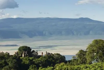 The forested rim and open floor of the Ngorongoro Crater seen from above