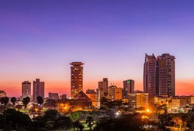 Nairobi skyline lit up against a violet dusk