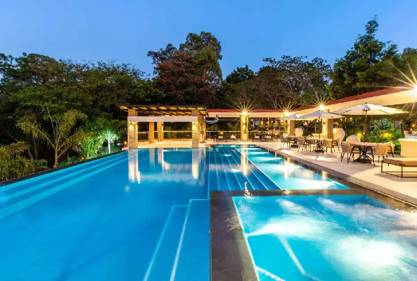 Floodlit swimming pool at Pax Manor at dusk